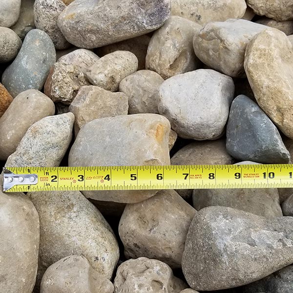 pile of large indian creek gravel with measuring tape