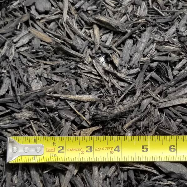 pile of black mulch with measuring tape