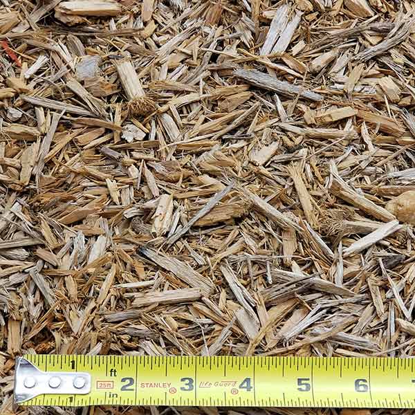 pile of kid safe playground mulch with measuring tape