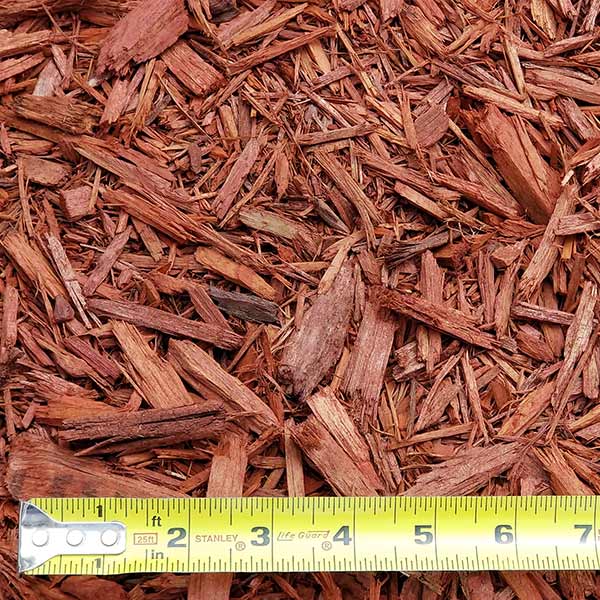 pile of red mulch with measuring tape