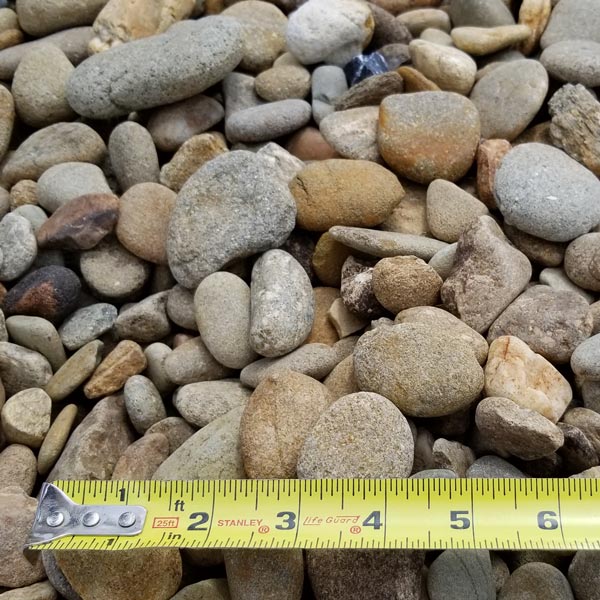 pile of small tennessee river rock with measuring tape