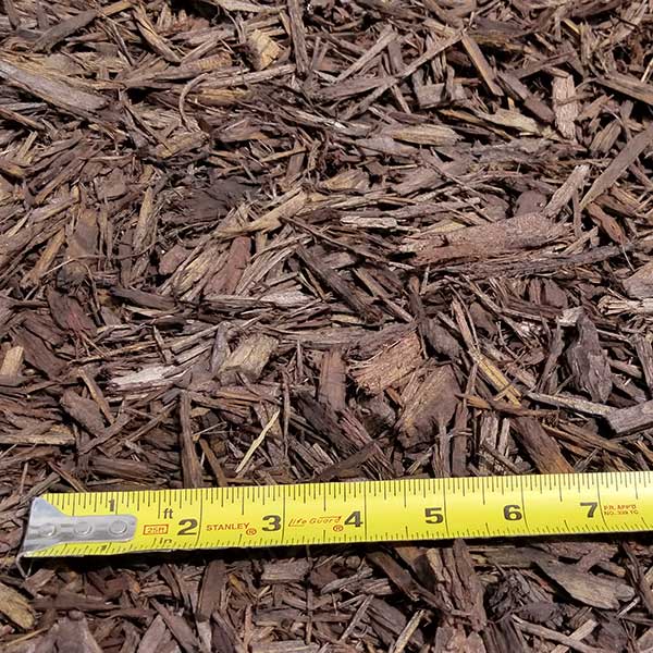 pile of dark brown mulch with measuring tape